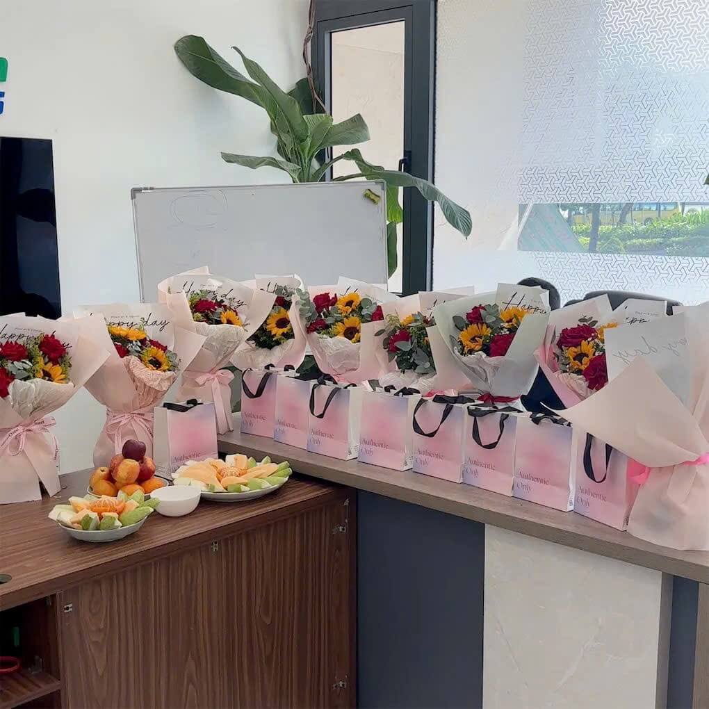 Rows of bouquets and gift bags on the office counter for Vietnamese Women's Day